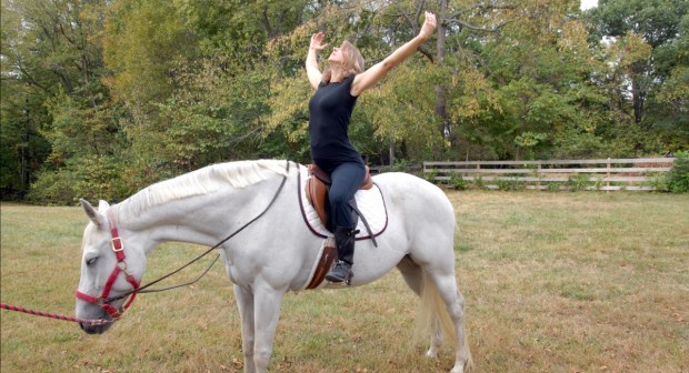 woman doing yoga while on horseback